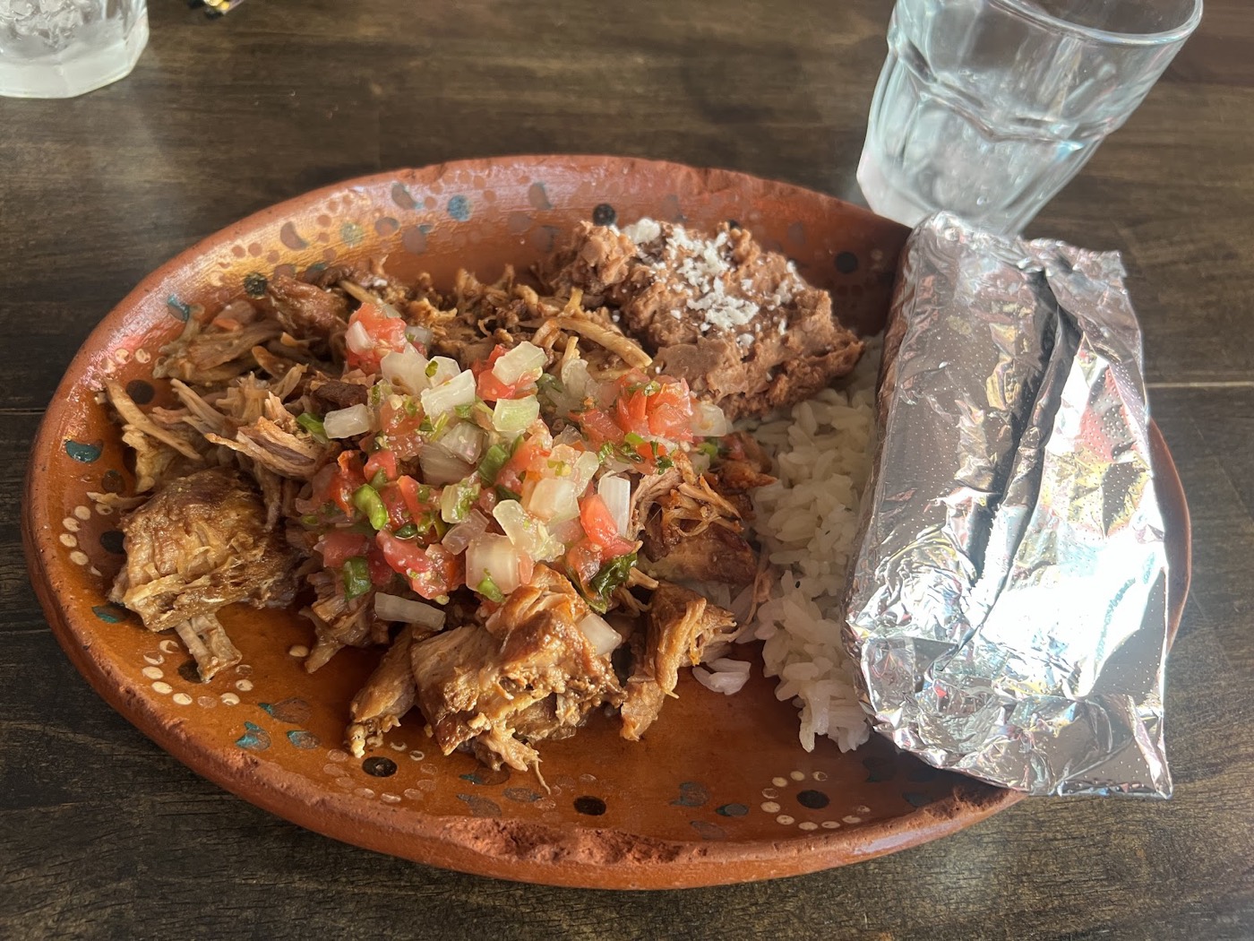 Carnitas plate with rice, beans, and handmade tortilla