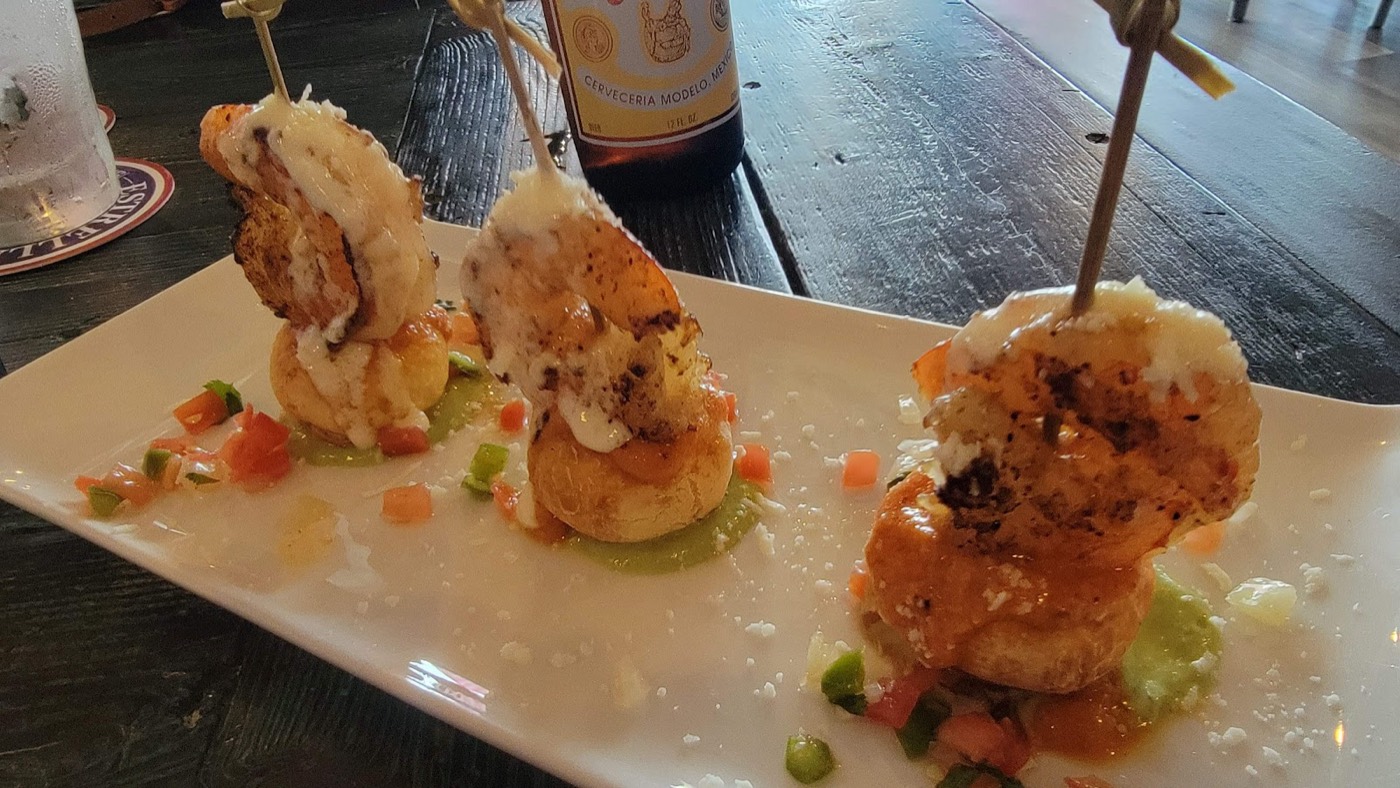 Grilled shrimp appetizer bites plated with salsa