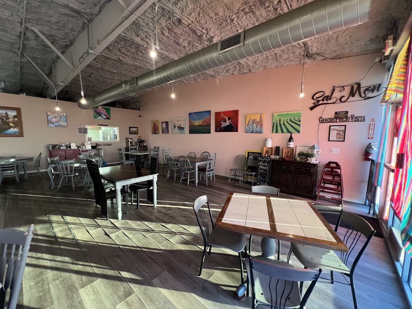 Colorful dining room at Sal-O-Mon Family Restaurant with local artwork on the walls